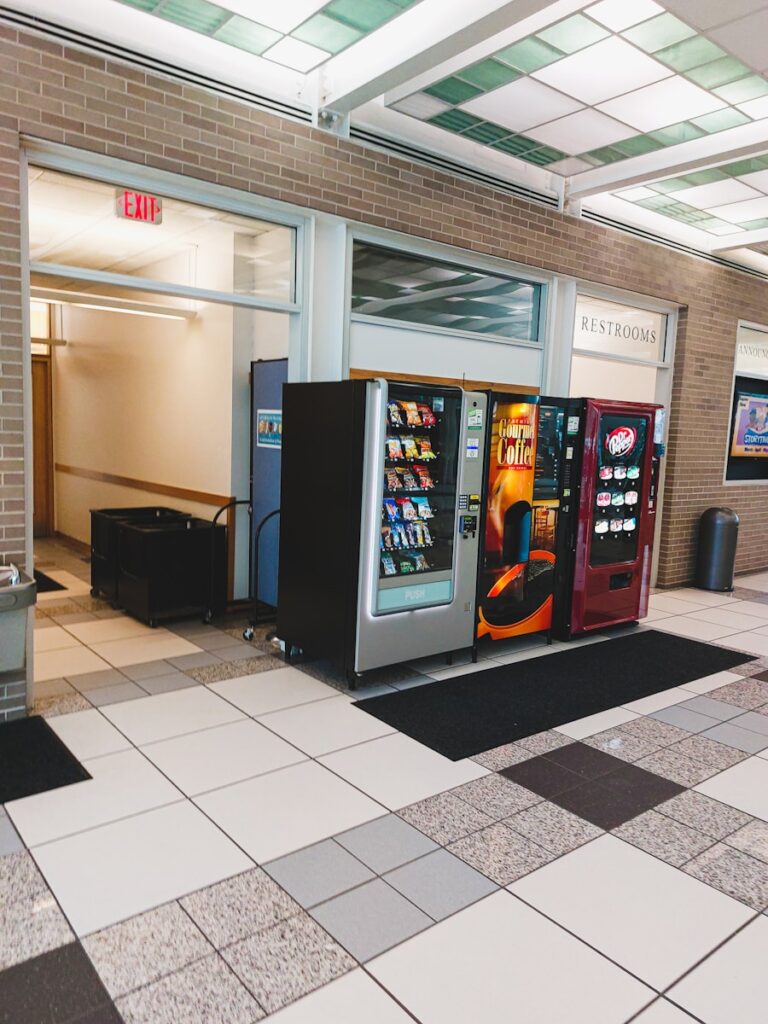 a row of vending machines sitting inside of a building