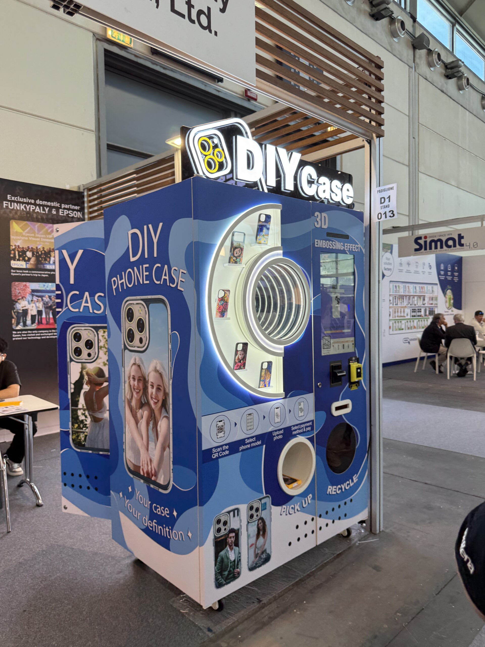 Custom phone case printing vending machine presented as a venue attraction rather than vending