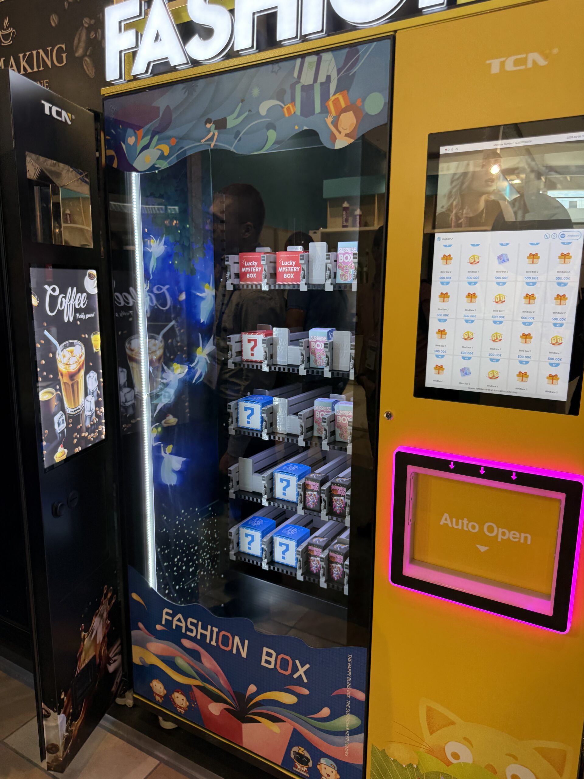 Trading card and blind box vending machine with lit display case and large touchscreen, built to attract attention