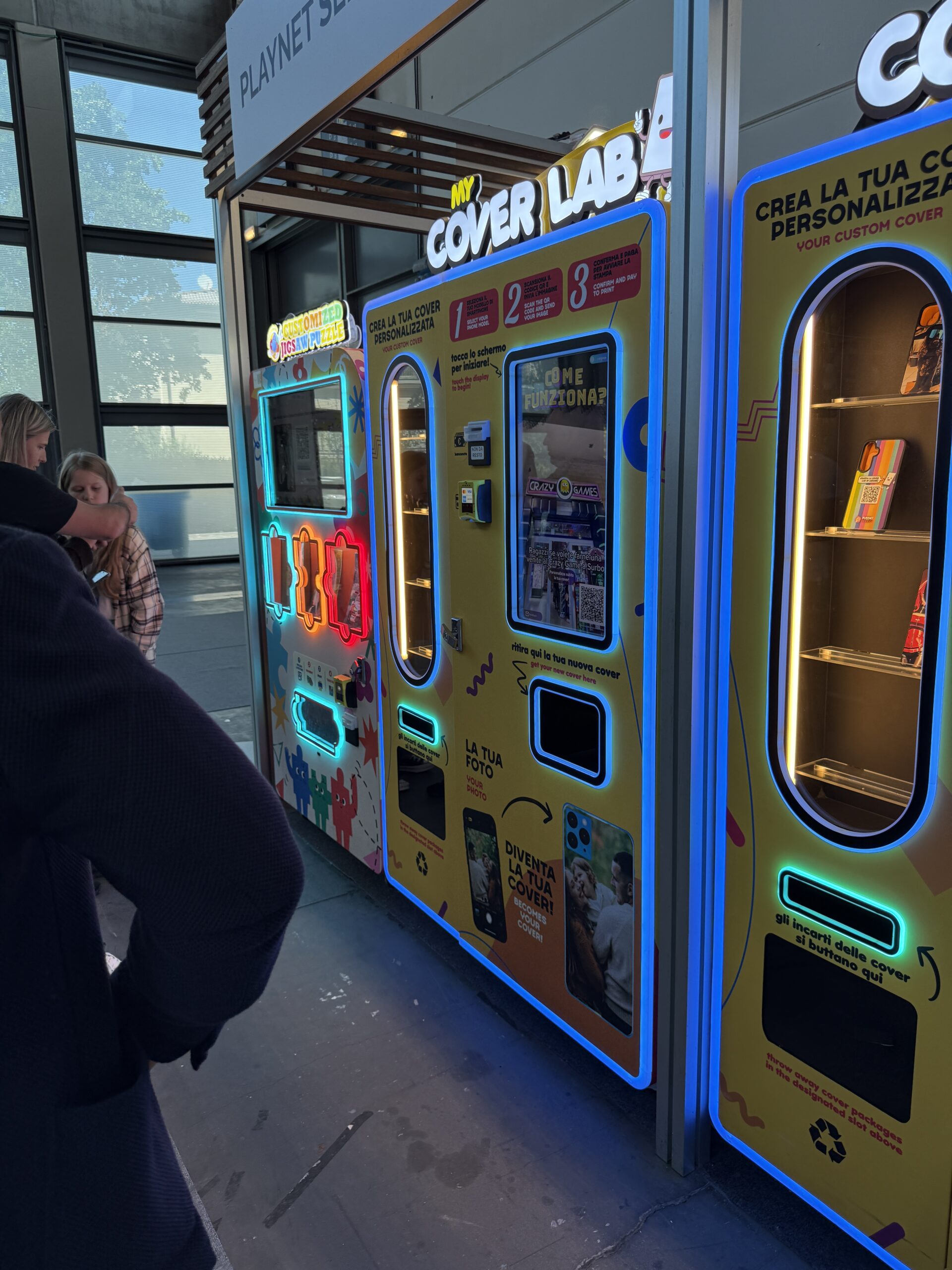 Bank of brightly lit personalisation vending machines