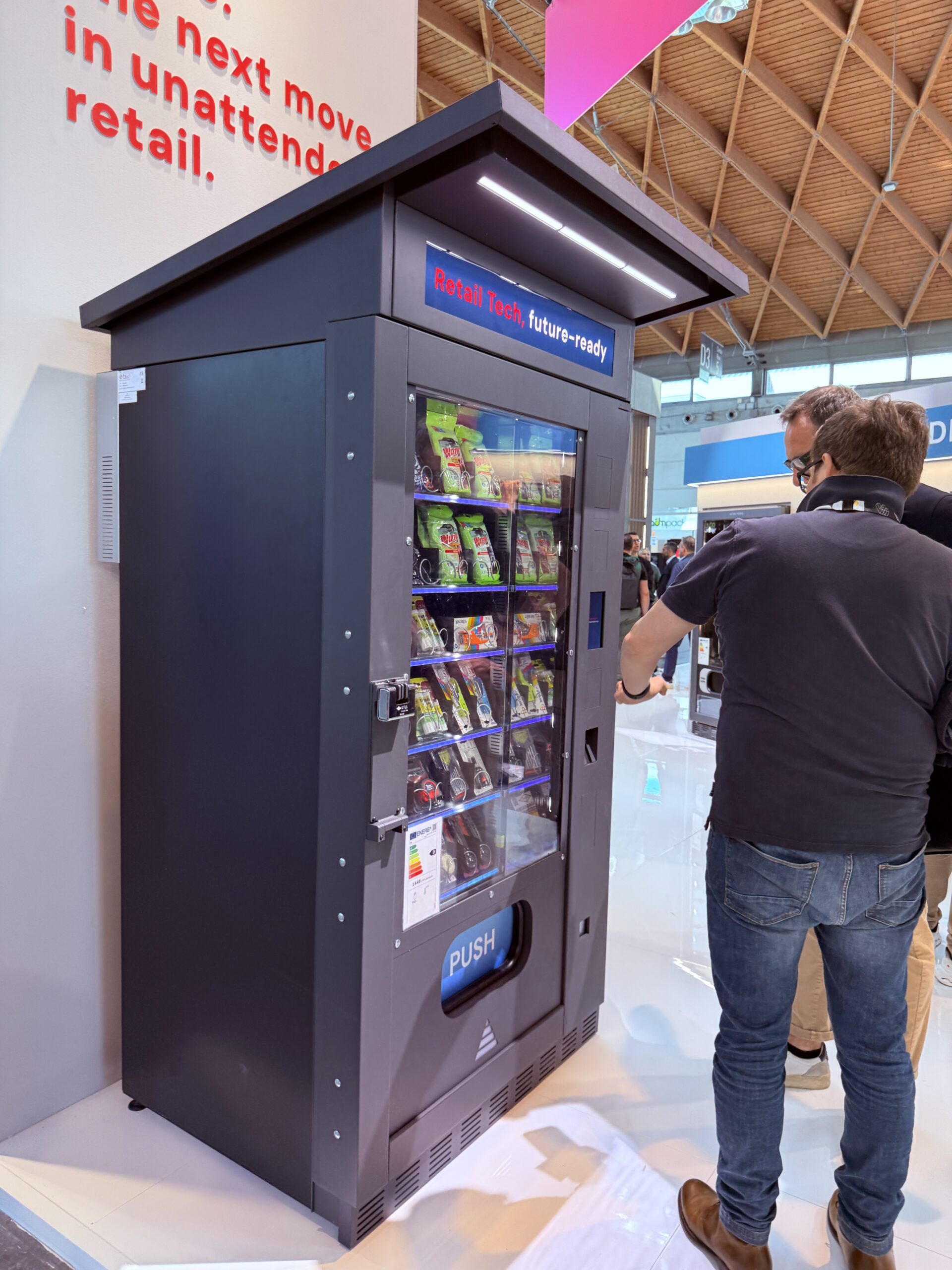 Outdoor vending machine positioned by a building entrance
