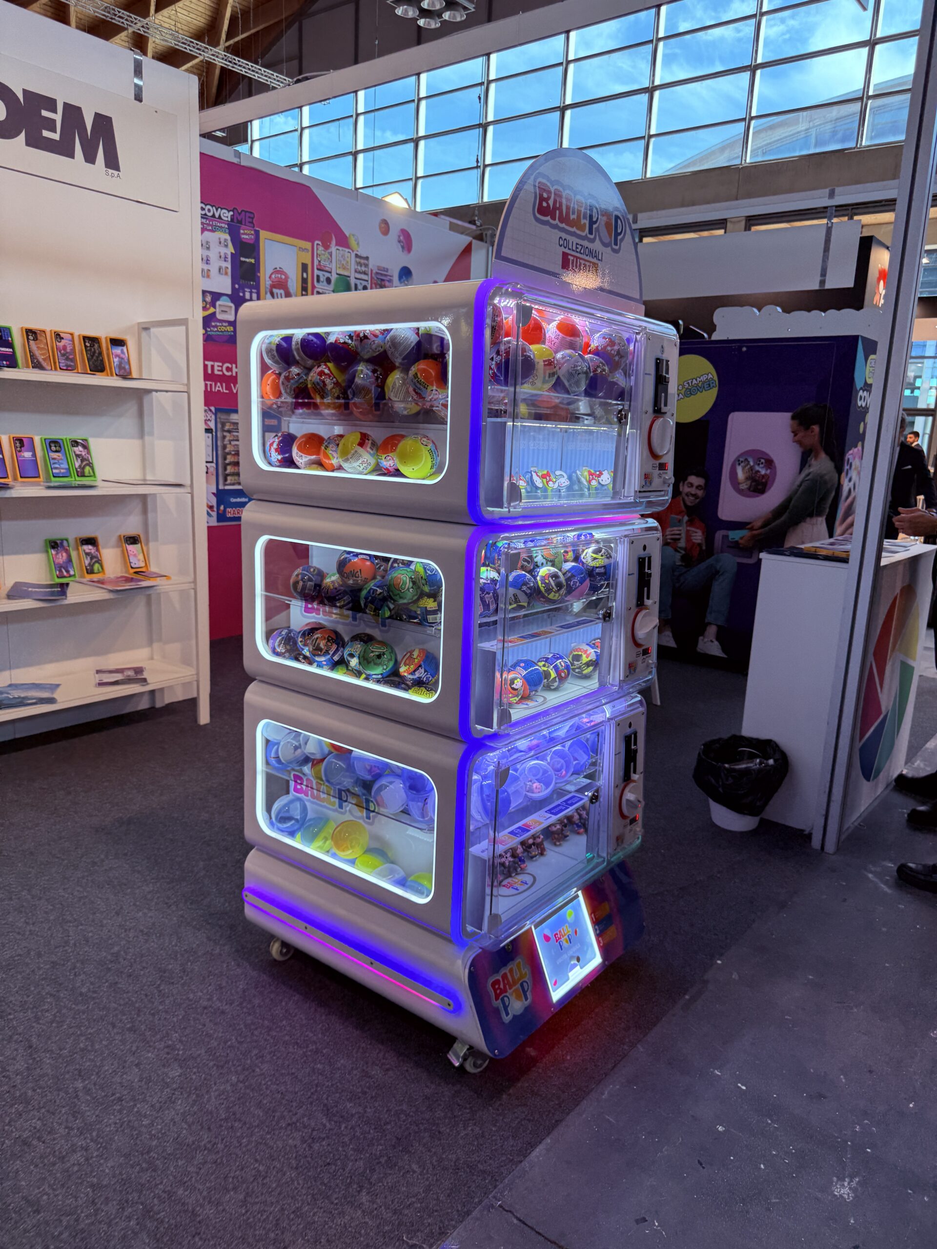 Capsule vending machine window with colourful capsules visible behind glass