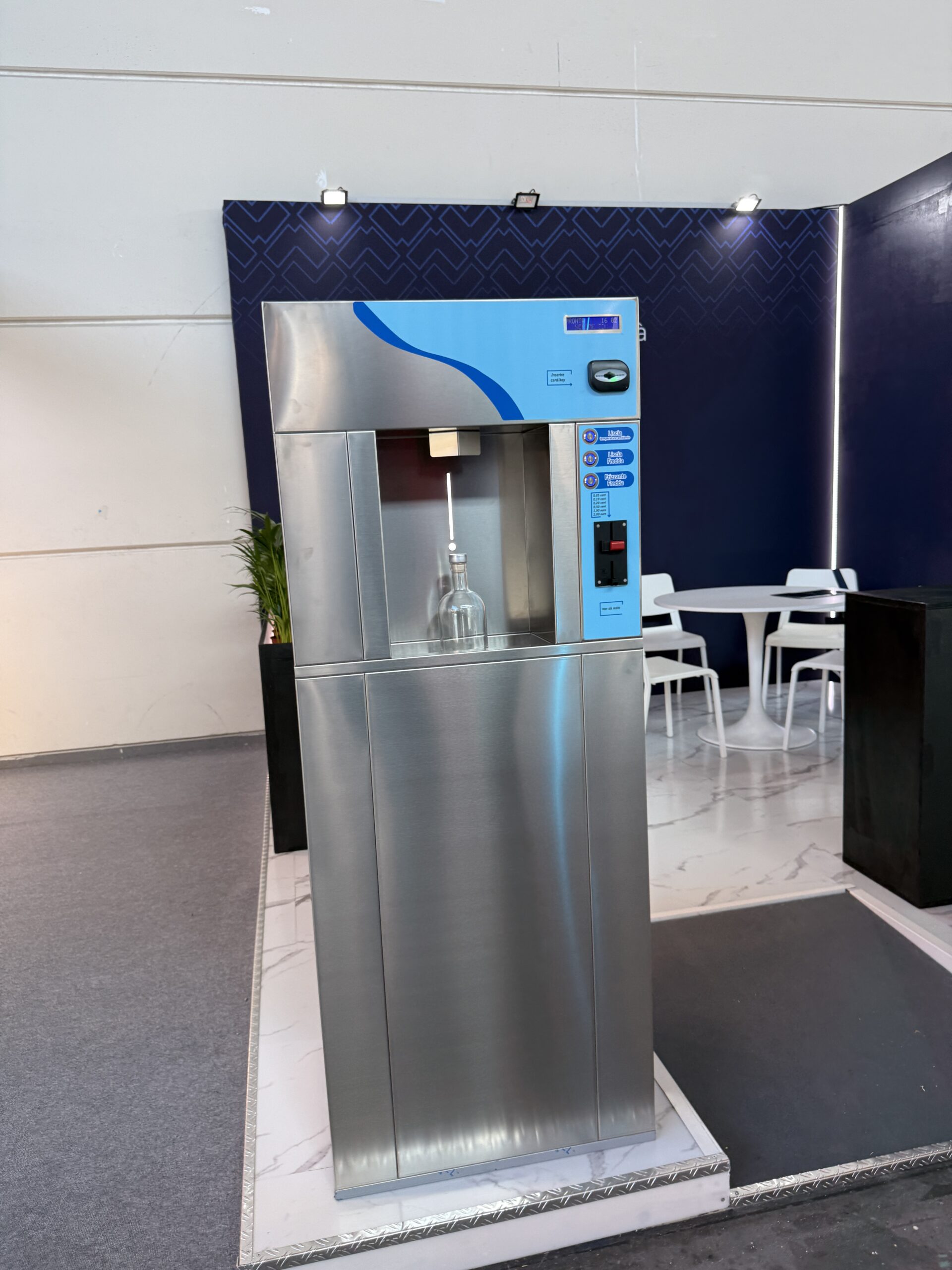 Water refill machine panel showing still, sparkling and ambient options with payment